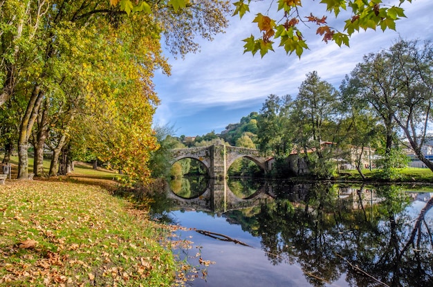 Medieval bridge over Arnoia river in Allariz Ourense Spain in autumn