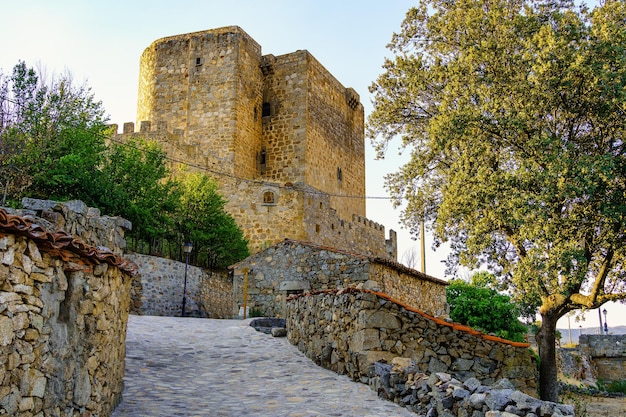 Medieval castle with its tower and wall at sunset on a summer day Puente Congosto Salamanca