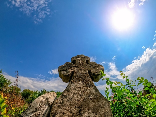 Medieval cross monument with carved inscription Ancient stone cross close up