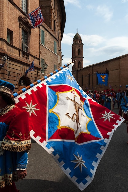 A medieval flag with a panther in a parade during the palio in Siena Italy