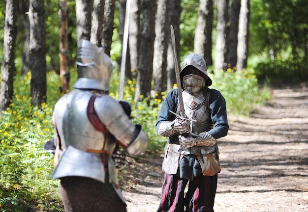 Medieval knights fighting with swords