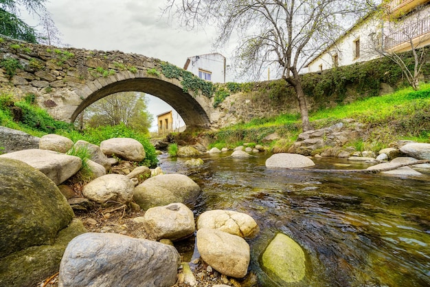 Medieval stone bridge that crosses over the river of Hervas Caceres