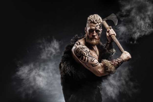 Photo medieval warrior viking with tattoo and axe