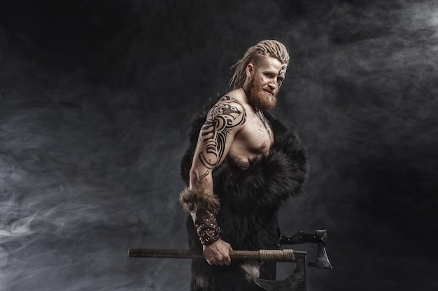 Medieval warrior Viking with tattoo and axe