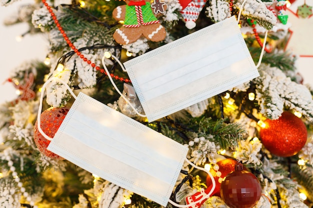 Medisch gezichtsmasker hangend aan versierde kerstboom