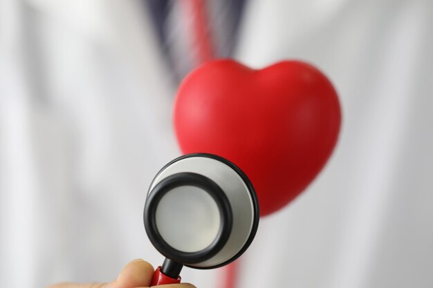 Foto medisch stethoscoopinstrument luister naar rood plastic hart