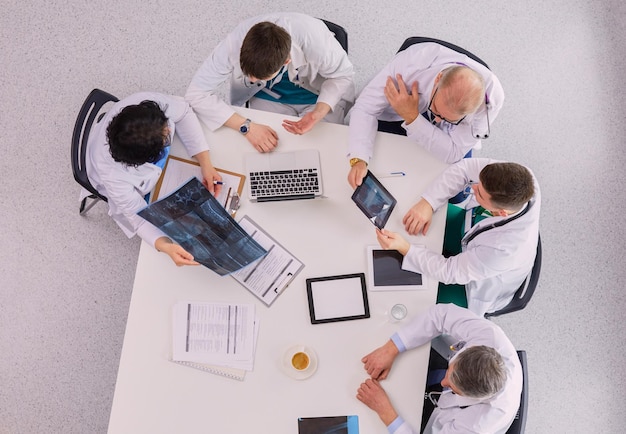 Medisch team zitten en discussiëren aan tafel bovenaanzicht