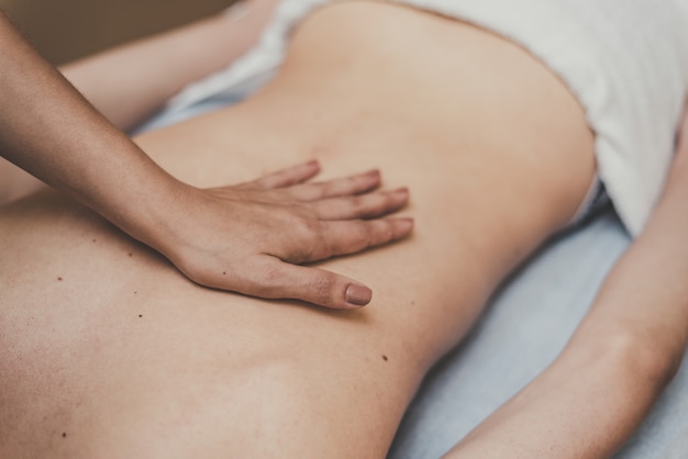 Medische massage van de wervelkolom. Masseur masseert een tiener in een kliniek