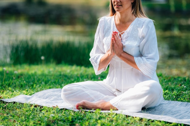 Photo meditation by the water hands in prayer position