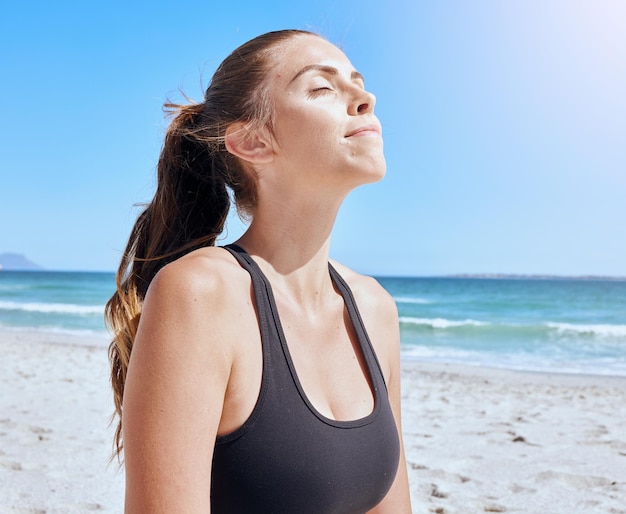 Meditation relax and woman with peace at beach breathing and doing yoga for freedom Health wellness and calm girl training her mind with a spiritual exercise for faith in the morning by the sea