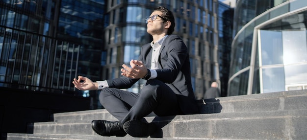 Meditation yoga relieved stress by a man in a business\
suit