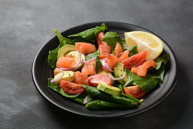 Mediterranean Avocado Salmon Salad  with spinach, cherry tomatoes, avocado and red onion dressing