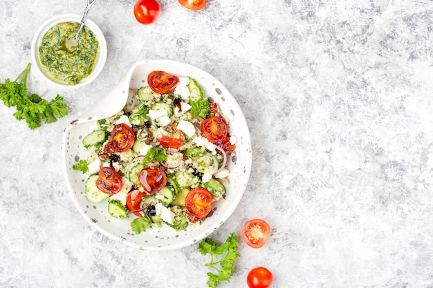 Mediterranean couscous salad with fried cherry tomatoes, cucumber and pesto sauce