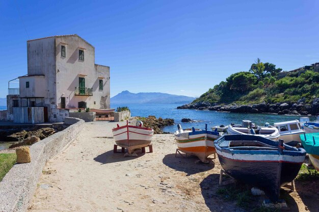 Mediterranean house on the beach with a wooden boat horizontal