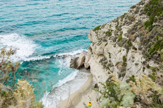 Mediterranean seascape, blue sea, rocks on the coast, summer day. Calabrian beach, near Tropea