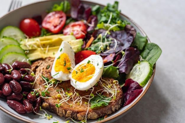 Medium boiled eggs with sasld healthy breakfast