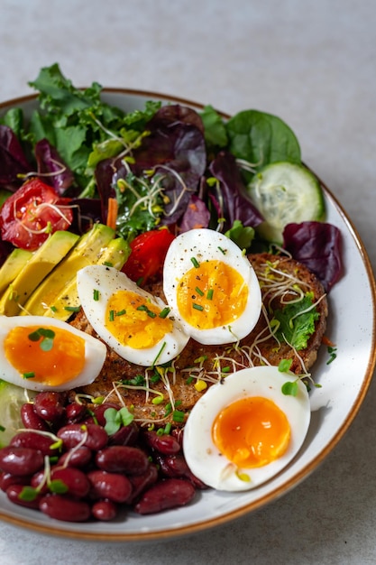 Medium boiled eggs with sasld healthy breakfast