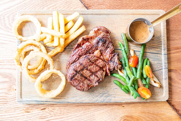 medium rare beef steak with vegetable and french fries