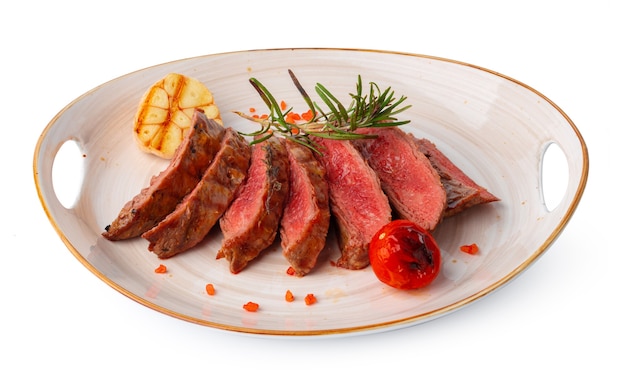 Medium rare grilled beef steak isolated on white