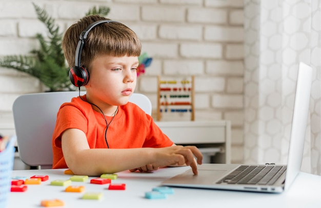 写真 ヘッドホンをつけているミディアムショットの少年