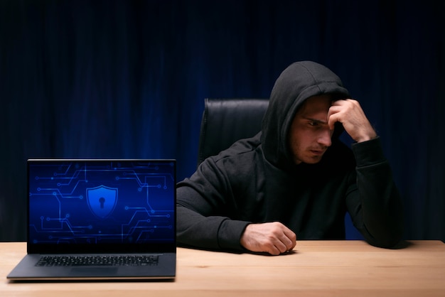 Medium shot concerned man sitting at desk