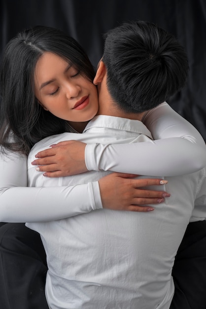 Medium shot couple posing in studio