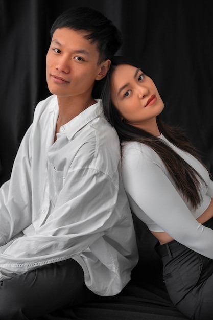 Medium shot couple posing in studio