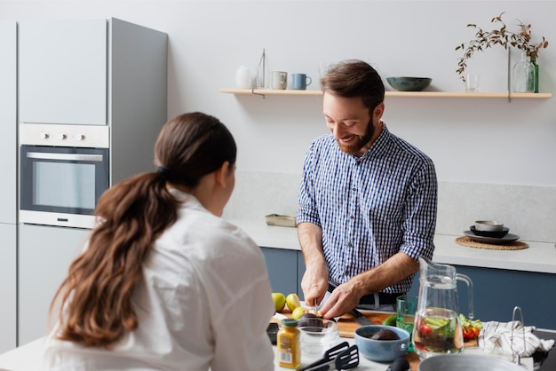 Medium shot couple preparing food