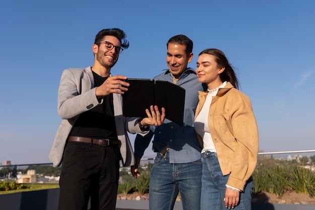 Medium shot couple talking to real estate agent