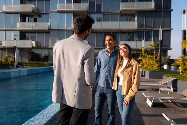 medium shot couple talking to real estate agent