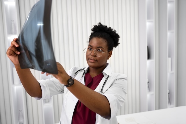 Medium shot doctor holding radiography