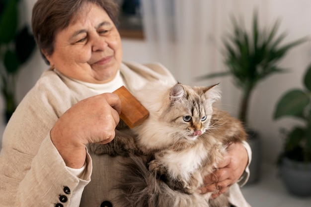 medium shot elderly woman with cat