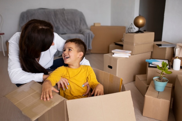 Medium shot family ready to move into a new home