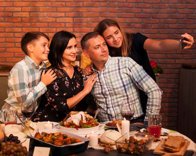 Medium shot family taking selfie