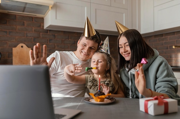 Medium shot family wearing party hats