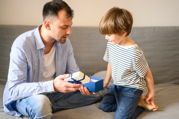 Medium shot father holding gift