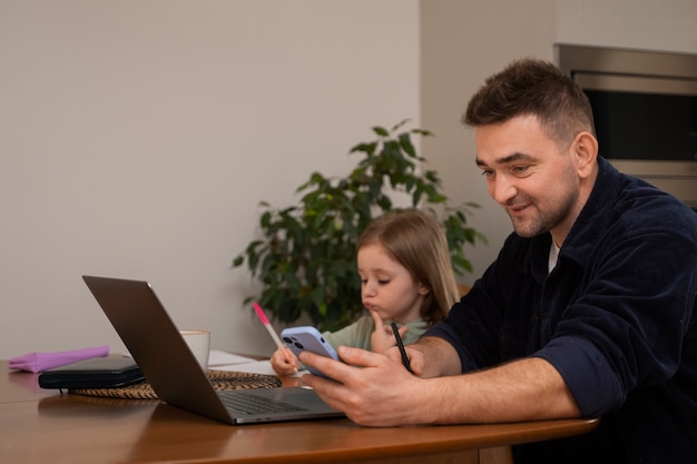 medium shot father working with kid at home