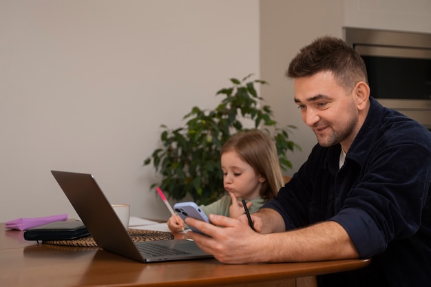 Medium shot father working with kid at home