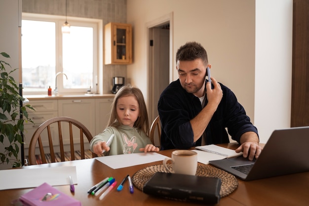 Medium shot father working with kid at home