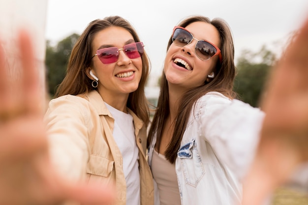 Medium shot friends taking selfie