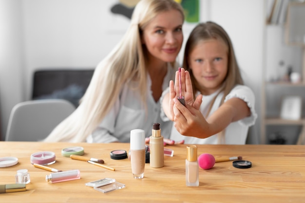 Photo medium shot girl holding lip gloss brush