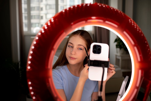 Medium shot girl recording her makeup routine