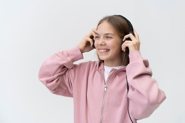 Medium shot girl wearing headphones