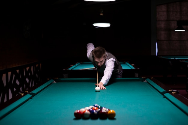 Medium shot guy with suit playing billiard