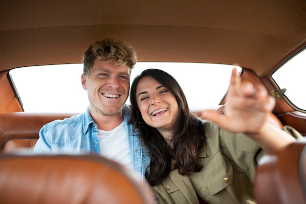 Medium shot happy couple in car