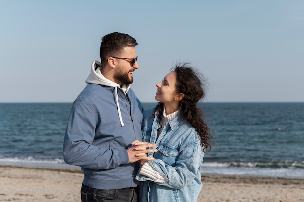 Medium shot happy couple at seaside