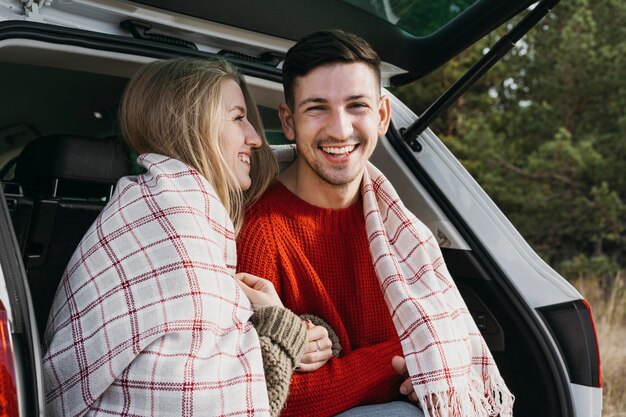 Medium shot happy couple with blanket