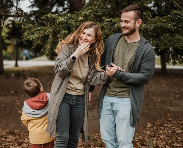 medium shot happy family outdoors