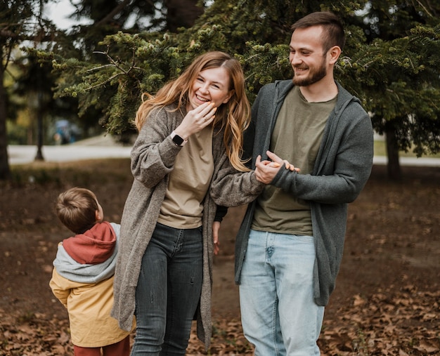 Medium shot happy family outdoors