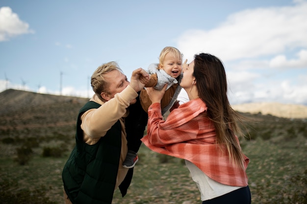 Medium shot happy family outside